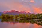 USA, Montana, Allentown. Evening light of Mission Mountains reflected in small pond. Art Print